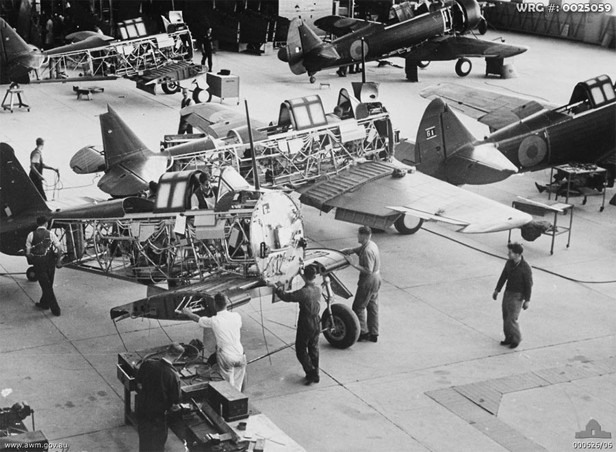 Fishermen's Bend, Vic. 1940-02-02. At the Commonwealth Aircraft Corporation Factory, employees move a partly constructed Wirraway to a more advanced position in the assembly line.